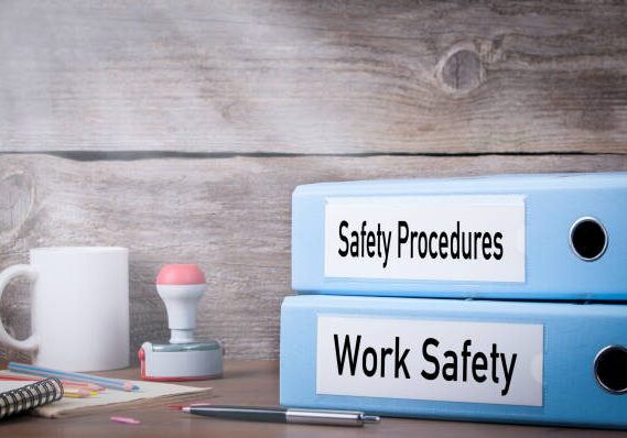 Work Safety and Safety Procedures. Two binders on desk in the office. Business background.